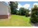 Spacious backyard featuring well-kept lawn and ample space for outdoor activities and gardening at 7301 Cranleigh St, Covington, GA 30014