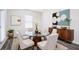 Stylish dining room features decor, art, and a modern glass top table with seating for four at 7301 Cranleigh St, Covington, GA 30014