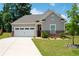 Inviting home featuring a well-kept lawn and a convenient two-car garage at 7301 Cranleigh St, Covington, GA 30014