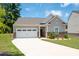 Charming single-story home with a two-car garage and a well-manicured lawn at 7301 Cranleigh St, Covington, GA 30014