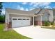 Attractive single-story home with a two-car garage and lush green grass at 7301 Cranleigh St, Covington, GA 30014