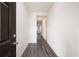 Bright hallway featuring sleek, modern flooring and fresh, white walls at 7301 Cranleigh St, Covington, GA 30014