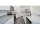 Well-lit kitchen with granite counters, stainless appliances, white cabinets, and a spacious island with a sink at 7301 Cranleigh St, Covington, GA 30014
