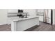 Modern kitchen featuring white cabinets, a large island, and stainless steel appliances at 7301 Cranleigh St, Covington, GA 30014