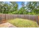 Backyard featuring a lawn, a wooden fence, and shade trees at 5312 Brooklands Dr, Lithonia, GA 30058