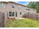 Fenced backyard features a lawn with patio for outdoor activities and entertaining at 5312 Brooklands Dr, Lithonia, GA 30058