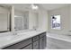 A luxurious bathroom features double sinks, tub, and a shower at 5312 Brooklands Dr, Lithonia, GA 30058