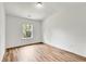 A bright bedroom with wood-look floors and a large window at 5312 Brooklands Dr, Lithonia, GA 30058