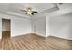 Bright bedroom with tray ceiling, ceiling fan, and wood floors at 5312 Brooklands Dr, Lithonia, GA 30058
