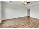 Bright bedroom with tray ceiling, ceiling fan, and wood floors at 5312 Brooklands Dr, Lithonia, GA 30058