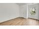 Bright bedroom featuring wood-look flooring, a window, and neutral paint at 5312 Brooklands Dr, Lithonia, GA 30058