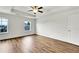 Bright bedroom with tray ceiling, ceiling fan, and wood floors at 5312 Brooklands Dr, Lithonia, GA 30058