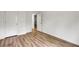 Bedroom with wood-look floors, neutral walls, and ample closet space at 5312 Brooklands Dr, Lithonia, GA 30058