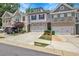A row of townhomes with attached garages and driveways, showcasing a well-maintained exterior at 5312 Brooklands Dr, Lithonia, GA 30058