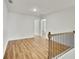 Hallway with wood floors and black metal railing at 5312 Brooklands Dr, Lithonia, GA 30058