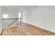 Hallway with wood floors and black metal railing at 5312 Brooklands Dr, Lithonia, GA 30058
