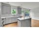 Bright kitchen features an island, white countertops, gray cabinets, and stainless steel appliances at 5312 Brooklands Dr, Lithonia, GA 30058