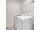 Modern laundry room featuring a new washer and dryer and shelving at 5312 Brooklands Dr, Lithonia, GA 30058
