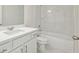 Bright, modern bathroom with marble tile, vanity, and a combined tub and shower at 5816 Creek Indian Dr, Sugar Hill, GA 30518