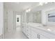 Modern bathroom featuring dual sinks, a glass shower and neutral tile flooring at 5816 Creek Indian Dr, Sugar Hill, GA 30518