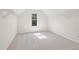 Bright bedroom featuring neutral carpet and a window with scenic views at 5816 Creek Indian Dr, Sugar Hill, GA 30518