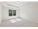 Bright bedroom featuring neutral carpet and a window with scenic views at 5816 Creek Indian Dr, Sugar Hill, GA 30518