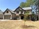 Attractive two-story home with a gray roof, neutral brick, an attached two-car garage, and a manicured front yard at 5816 Creek Indian Dr, Sugar Hill, GA 30518