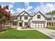 Charming two-story home with a well-manicured lawn, an attached two-car garage, and neutral brick at 5816 Creek Indian Dr, Sugar Hill, GA 30518