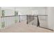 Upstairs hallway featuring rod iron bannister and neutral carpet at 5816 Creek Indian Dr, Sugar Hill, GA 30518