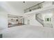 Expansive open-concept living room with tall ceilings, a fireplace, and views of the kitchen and second level at 5816 Creek Indian Dr, Sugar Hill, GA 30518
