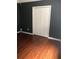 Bedroom featuring hardwood floors, dark gray walls, and a double door closet at 144 Boones Ridge Se Pkwy, Acworth, GA 30102