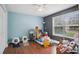 Bedroom featuring hard floors, a ceiling fan, and natural light from the window at 144 Boones Ridge Se Pkwy, Acworth, GA 30102