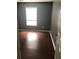 Bedroom featuring hardwood floors, gray walls, and natural light from a window at 144 Boones Ridge Se Pkwy, Acworth, GA 30102