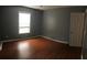 Bedroom featuring hardwood floors, gray walls, and natural light from a window at 144 Boones Ridge Se Pkwy, Acworth, GA 30102