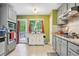 Kitchen features stainless appliances, granite countertops, and access to the deck at 144 Boones Ridge Se Pkwy, Acworth, GA 30102