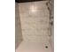 Modern bathroom shower with marble-style tile, a rainfall shower head, and chrome fixtures at 144 Boones Ridge Se Pkwy, Acworth, GA 30102