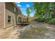 View of backyard featuring a trampoline and a wooden privacy fence bordering green trees at 2015 Chapel Estates Lane Southeast Ln, Dacula, GA 30019