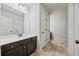 Bathroom with double doors to other rooms, dark wood cabinet and large mirror at 2015 Chapel Estates Lane Southeast Ln, Dacula, GA 30019