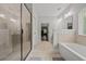 Bright bathroom featuring tiled floors, large walk-in shower, and a separate soaking tub at 2015 Chapel Estates Lane Southeast Ln, Dacula, GA 30019