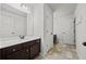 Bright bathroom with dark wood cabinets, white countertops, and large mirror at 2015 Chapel Estates Lane Southeast Ln, Dacula, GA 30019
