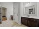 Bathroom showcasing double closets, dark vanity, white counter, and ceramic tile at 2015 Chapel Estates Lane Southeast Ln, Dacula, GA 30019