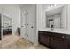 Bright bathroom with dark wood cabinets, white countertops, and large mirror at 2015 Chapel Estates Lane Southeast Ln, Dacula, GA 30019