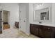 Bright bathroom with dark wood cabinets, white countertops, and large mirror at 2015 Chapel Estates Lane Southeast Ln, Dacula, GA 30019