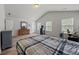 Spacious bedroom featuring vaulted ceilings, hardwood floors, and abundant natural light from two large windows at 2015 Chapel Estates Lane Southeast Ln, Dacula, GA 30019