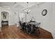 Chic dining room featuring hardwood floors, modern chandelier, and detailed wall trim at 2015 Chapel Estates Lane Southeast Ln, Dacula, GA 30019