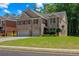 Beautiful home showcasing its brick facade, red shutters, and green lawn at 2015 Chapel Estates Lane Southeast Ln, Dacula, GA 30019