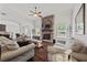 Inviting living room featuring a stone fireplace, hardwood floors, and comfortable seating at 2015 Chapel Estates Lane Southeast Ln, Dacula, GA 30019