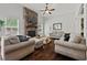 Comfortable living room with a stone fireplace and hardwood floors at 2015 Chapel Estates Lane Southeast Ln, Dacula, GA 30019