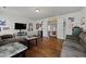 Open-concept living room with hardwood floors, comfortable seating, and access to other rooms at 2015 Chapel Estates Lane Southeast Ln, Dacula, GA 30019