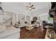 Open-concept living room with hardwood floors, columns and view of the kitchen at 2015 Chapel Estates Lane Southeast Ln, Dacula, GA 30019